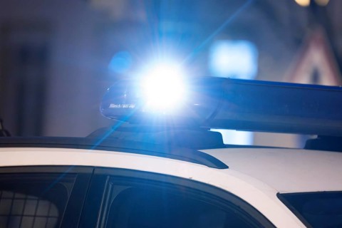 Symbolic image police operation: close-up of a blue light on a police car (digitally reworked)