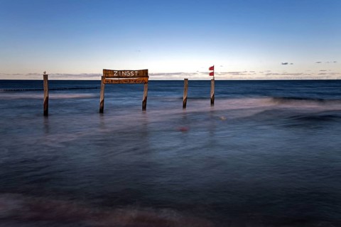 Wooden sign in the sea with inscription Zingst, long exposure, evening light, Zingst,