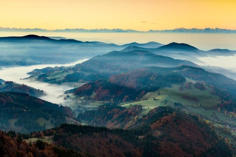 View from Belchen heading south of Wiesental and the Swiss Alps, morning atmosphere with fog in