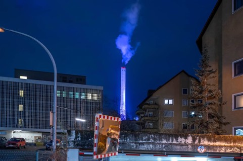 Glowing blue chimney from the CHP plant in the evening, Erlangen.Mittelfranken, Bavaria, Germany