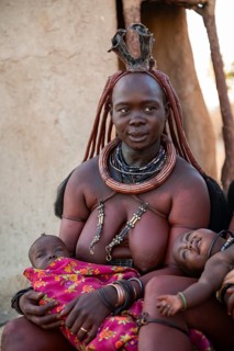 Himba woman with baby, traditional Himba village, Kaokoveld, Kunene, Namibia