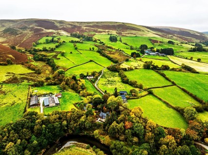 Autumn colours of Farms over River Wye and Road A470 from a drone, Llanidloes, Powys,