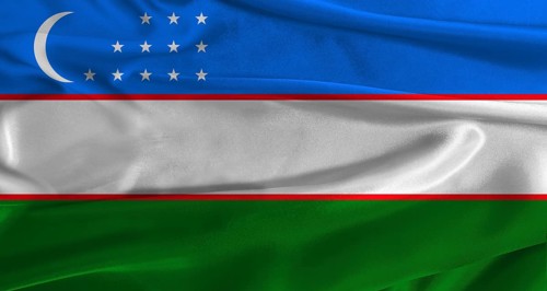 Flag of Uzbekistan with fabric textured background. Close up of National flag of Uzbekistan with