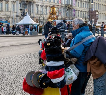 Street vendor wearing Russian army and fur caps, Karl-Liebknecht-Straße, Berlin, Germany