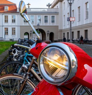 Detailed photo, headlights on a red Vespa, Berlin, Germany