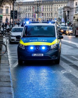 Police vehicles with flashing lights switched on, special operation at the Berlin State Library,
