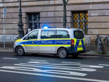 Police vehicles with flashing lights switched on, special operation at the Berlin State Library,