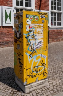 Deutsche Post letterbox with stickers and graffiti, Potsdam, Brandenburg, Germany