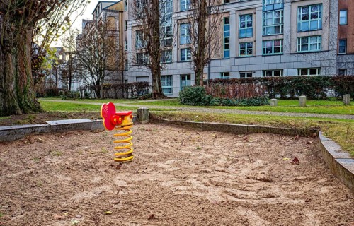 Orphaned children's playground with sandbox and small play equipment, Berlin, Germany