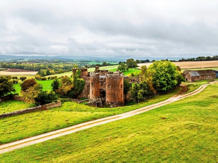 Autumn Colours over ruins of Pembridge Castle or Newland Castle from a drone, Herefordshire,