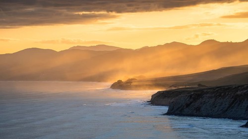 Wairarapa coast at sunset. Sea, mountains, backlight. Castlepoint, Wairarapa Coast, Wellington