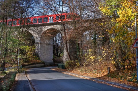 Regional train crosses the historic railway bridge, viaduct in Lauf, built in 1876,