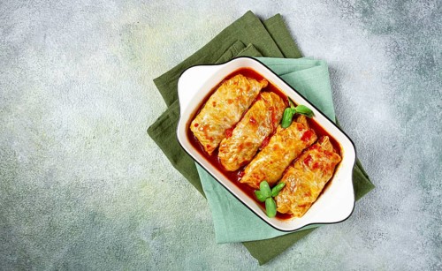 Stuffed cabbage rolls with minced meat, in tomato sauce, top view, without people, in the spotlight