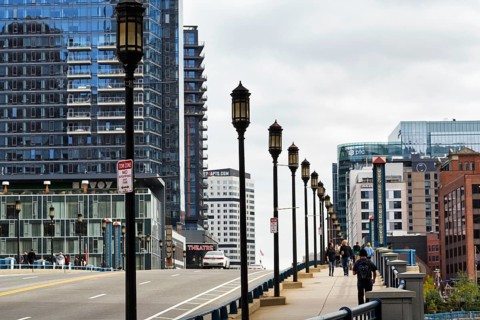Street lights on Congress Street Bridge, passers-by on pedestrian walkway, office towers, Financial