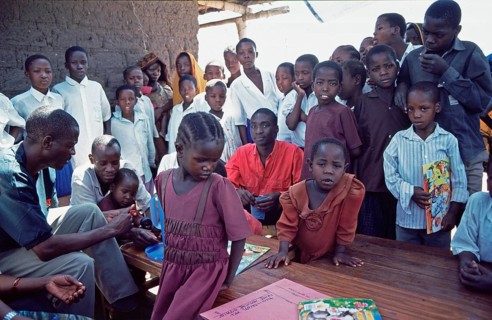 In a World Vision project, friends and neighbors have gathered on the occasion of a godfather's