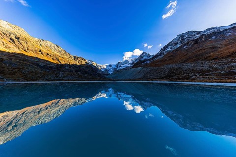 The Moiry glacier and mountain peaks are reflected in Lac de Chateaupre, Val d'Anniviers, Valais