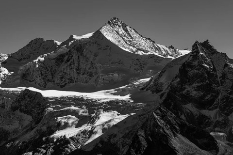 The snow-capped peaks of the Zinalrothorn and Besso mountains, black and white photo, Val