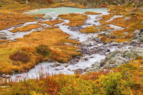 A glacier stream flows from Lac de Chateaupre into the Lac de Moiry reservoir, Val d'Anniviers,