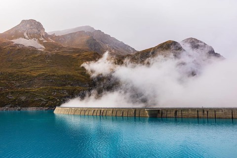 Fog rises over the dam of the Lac de Moiry Reservoir, Val d'Anniviers, Valais Alps, Canton of