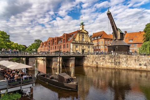Old harbour with crane and hotel department store in the Hanseatic city of Lüneburg, Lower Saxony,
