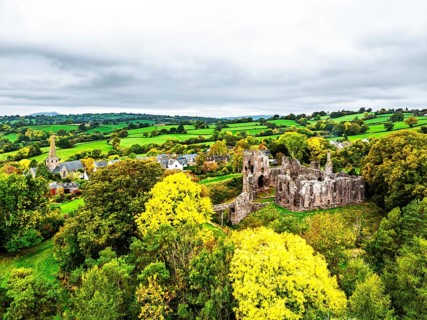 Autumn Colours over ruins of Grosmont Castle from a drone, Grosmont, Monmouthshire, Wales, UK