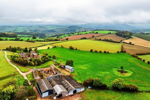 Autumn Colours over ruins of Pembridge Castle or Newland Castle from a drone, Herefordshire,
