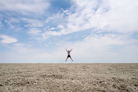 Symbolic picture, abstract, man jumping on the Etosha pan, salt pan, Etosha National Park, Namibia