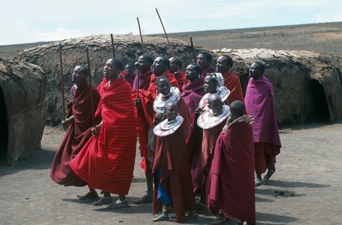 Maasai men and girls in their village in the Ngorongoro Crater dancing for tourists, Tanzania,