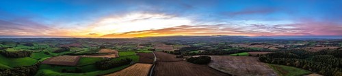 Sunset of Devon Farms and Fields over Berry Pomeroy from a drone, Totnes, England, United Kingdom