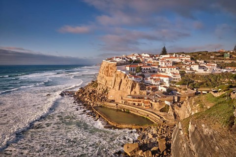 Scenic view of the seaside Azenhas do Mar fishing village on cliff on Atlantic ocean coast,