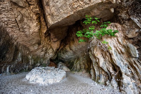 Stone men in a rock cave on the beach at Cala Luna, Golfo di Orosei, Baunei, Sardinia, Italy