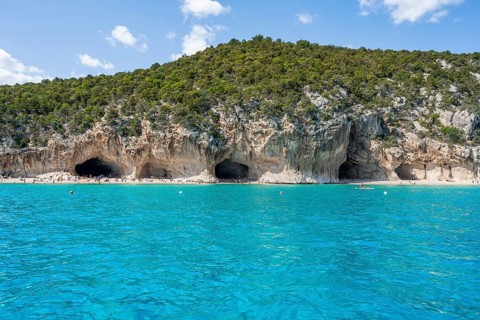Clear blue water and picturesque rocky coast, Cala Luna cliffs and beach, Golfo di Orosei, Baunei,
