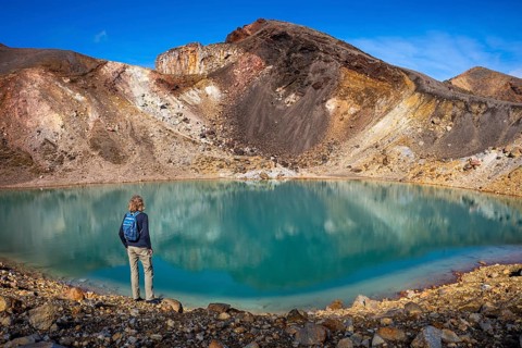 A hiker at one of the Emerald Lakes and Red Crater, Panorama, Tongariro alpine crossing, Tongariro