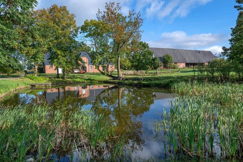 Historic horse stable and barn with pond, 1923, at the Othenstorf estate, Othenstorf,