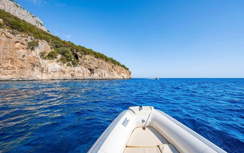Motorboat trip along the picturesque rocky coast, cliffs and blue sea, Golfo di Orosei, Baunei,