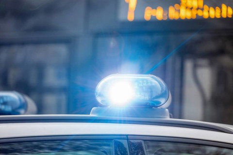 Symbolic image police operation: close-up of a blue light on a police car (digitally reworked)