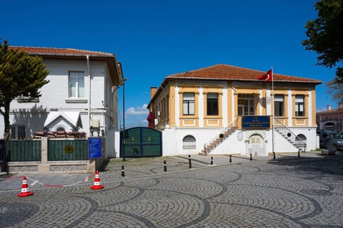 Cobblestone street with historic buildings and a Turkish flag, museum, Naval Museum, Canakkale,