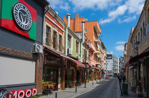 Colourful buildings along a busy shopping street on a sunny day, Yali Street, Canakkale, Marmara
