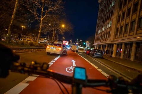Cycling in the city, in the dark, in the evening, cycling on a bike lane, marked, Huyssenallee,