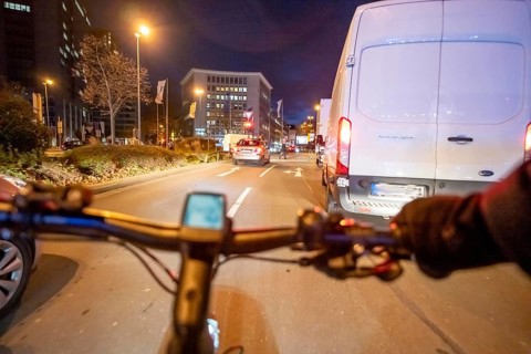 Cycling in the city, in the dark, in the evening, cycling on a bike lane, Huyssenallee, downtown