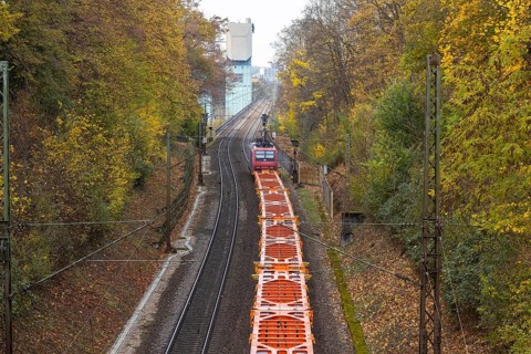 Freight train traveling on open route. Münster CHP plant. Stuttgart, Baden-Württemberg, Germany