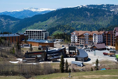A modern resort in the mountains with a breathtaking view of the surrounding hills, ski resort,