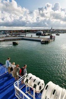 Tourists on the ferry to Rügen, ferry terminal, harbor with cityscape, St. Nicholas Church,