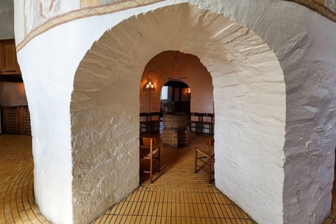 Medieval round church, baptistery with baptismal font, distinctive stone arches, interior,