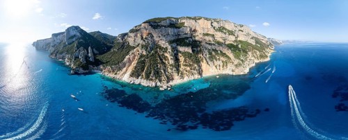 Panorama, picturesque rocky coast, cliffs with L'Aguglia pinnacle, blue sea and Cala Goloritzé