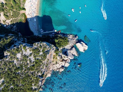 Picturesque rocky coast, cliffs and Cala Luna beach, aerial view, top-down, Golfo di Orosei,