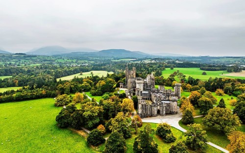 Autumn colours over Penrhyn Castle and Garden from a drone, Llandygai, Bangor, Gwynedd, North