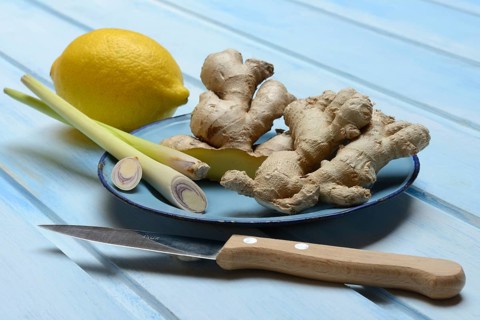 Ginger tubers with lemongrass on plate, lemon