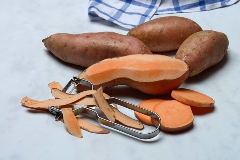 Sweet potatoes with potato peeler, Ipomoea batatas