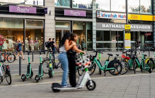 Electric scooters and rental bikes on public roads, Berlin, Germany